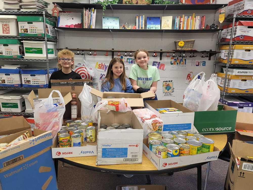 SMGS students count cans for the canned food drive